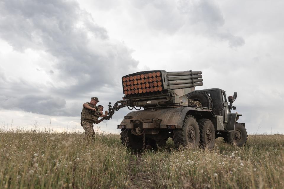 Ukrainian soldiers prepare a BM-21 artillery vehicle in its fighting position in the Donetsk region on July 23.