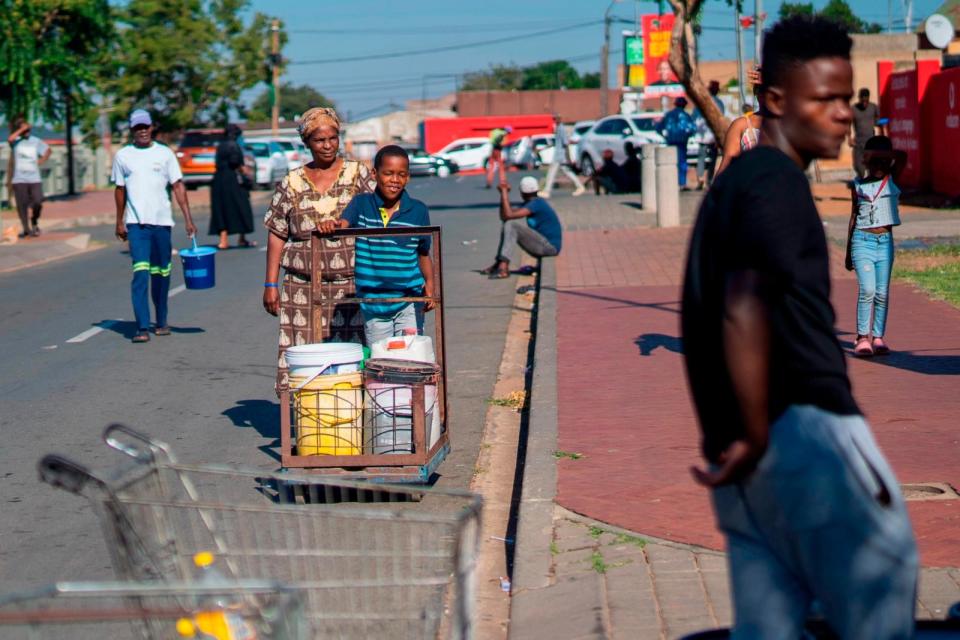 PHOTO: Residents of the township of Soweto, South Africa, queue for water, March 16, 2024.  (Jerome Delay/AP)