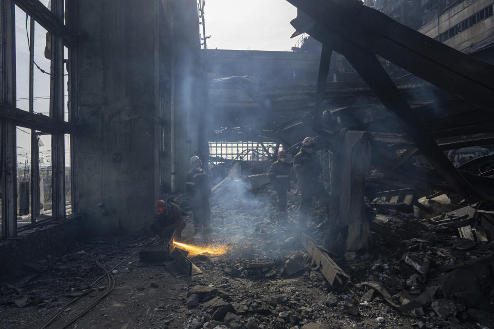 Workers clear the rubble after a Russian missile attack at DTEK's power plant in Ukraine, on Tuesday, April 2, 2024. Russia is attacking Ukraine’s energy sector with renewed intensity and alarming accuracy, signaling to Ukrainian officials that Russia is armed with better intelligence and fresh tactics in its campaign to annihilate the country’s power generation capacity. (AP Photo/Evgeniy Maloletka)