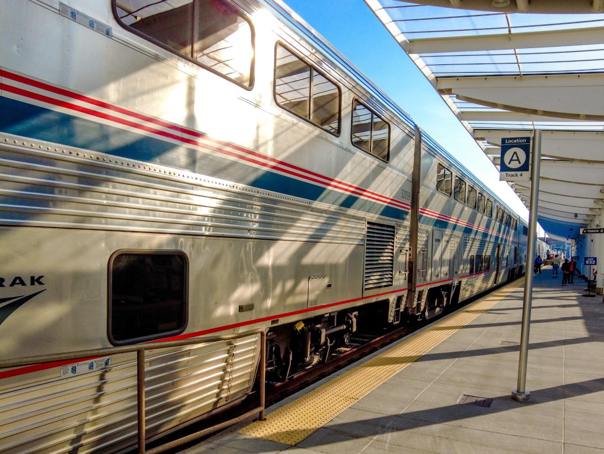 The silver, blue, and red Amtrak train at the concrete platform