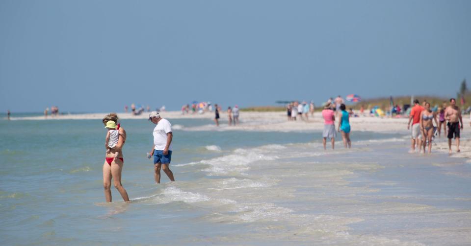 Sunbathers enjoy the beach at the Sanibel Lighthouse.