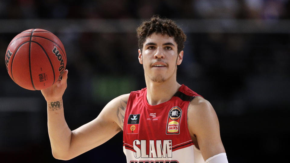 FILE - In this Nov. 17, 2019, file photo, LaMelo Ball of the Illawarra Hawks carries the ball up during their game against the Sydney Kings in the Australian Basketball League in Sydney.  LaMelo Ball's bone bruise on his left foot is expected to keep him out of the Illawarra Hawks lineup for the remainder of the National Basketball League season in Australia. The 18-year-old American, who joined Illawarra as part of the NBL's Next Stars program, is expected to be a first-round pick in this year's NBA draft.(AP Photo/Rick Rycroft, File)