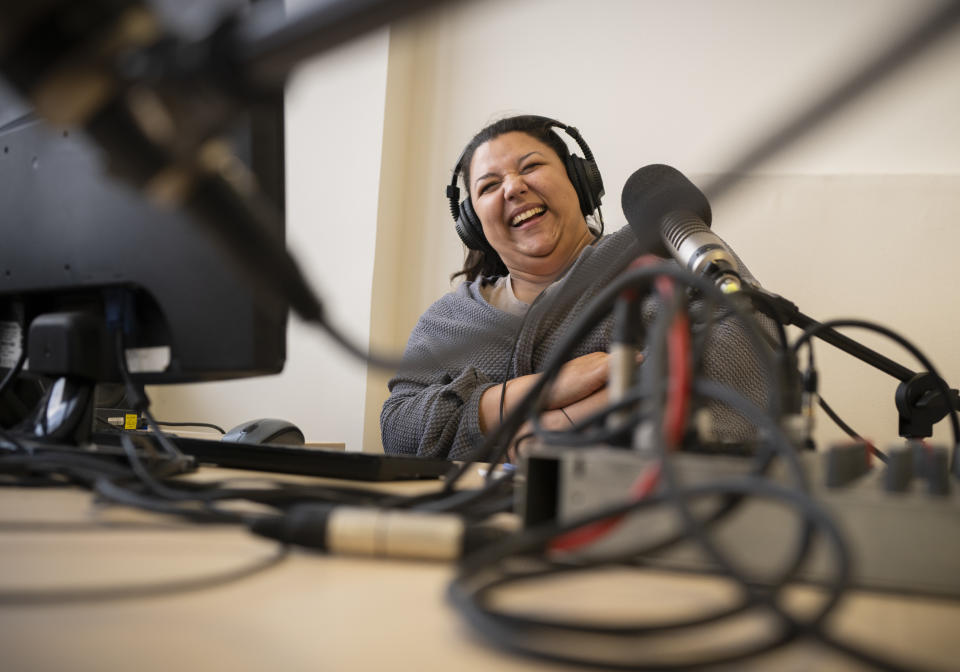 Bettina Pocsai, co-host of Radio Dikh's women's show 'Our Voice' works in a radio studio in Budapest, Hungary, Friday May 6, 2022. Intellectuals, broadcasters and cultural figures from Hungary’s Roma community have founded a radio station to reframe narratives and elevate the voices of their marginalized minority group. (AP Photo/Bela Szandelszky)