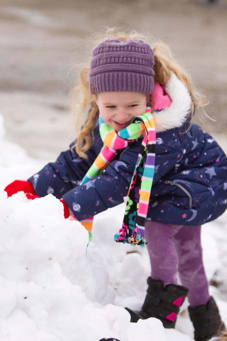 A child plays in the snow in Livingston County. Meteorologists predict a warm, snow-free Christmas this year.