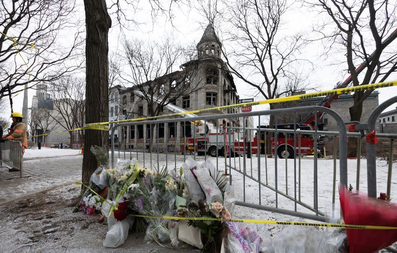 Canadian investigators inspect a heritage building before the search for seven unaccounted people after a fire in Montreal