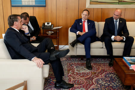 Brazil's President Jair Bolsonaro (L) talks with President of the Supreme Court of Justice of Venezuela in exile Miguel Angel Martin (2nd R) and the representative of the Organization of American States Gustavo Cinosi, during a meeting at Planalto Palace, in Brasilia, Brazil, January 17, 2019. Alan Santos/Presidency Brazil/Handout via Reuters