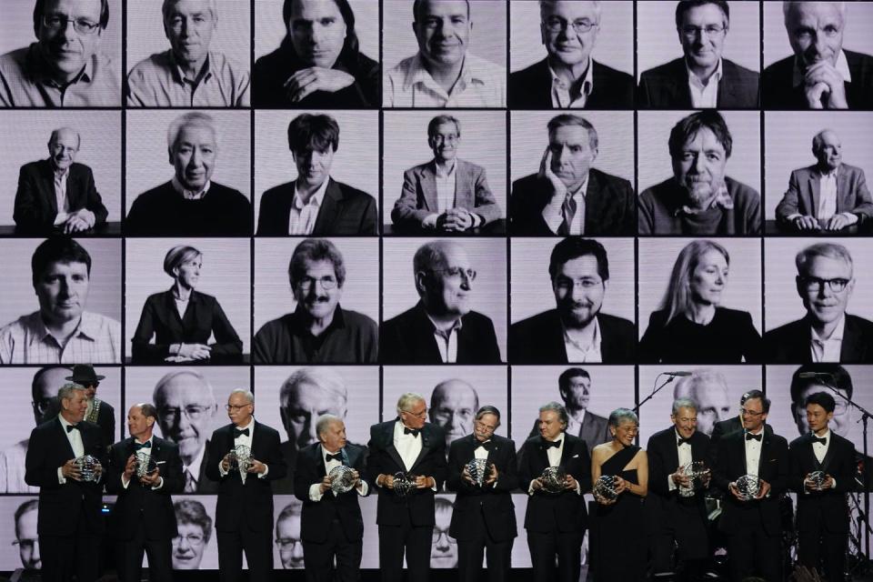 people on stage holding awards