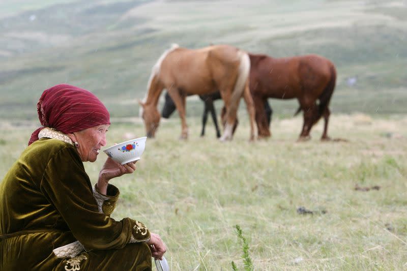 FILE PHOTO: A Kyrgyz woman drinks horse milk at a high-altitude summer pasture called Suusamyr, south of the capital Bishkek