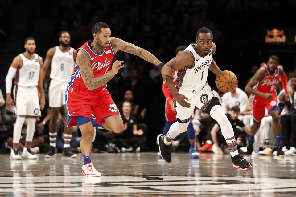 Philadelphia 76ers forward Mike Scott (1) defends against Brooklyn Nets guard Theo Pinson (1) during the first quarter of an NBA basketball game at Barclays Center, Sunday, Dec. 15, 2019, in New York. (AP Photo/Michael Owens)