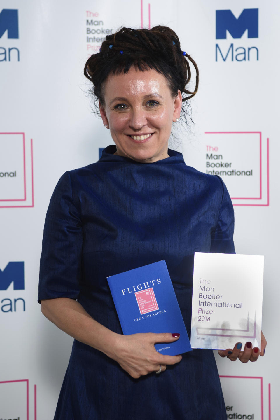 FILE - In this file photo dated May 22, 2018, Polish author Olga Tokarczuk after winning the Man Booker International prize 2018, for her book Flights. Polish novelist Olga Tokarczuk was named Thursday Oct. 10, 2019, winner of the 2018 Nobel Prize for literature. (Matt Crossick/PA FILE via AP)