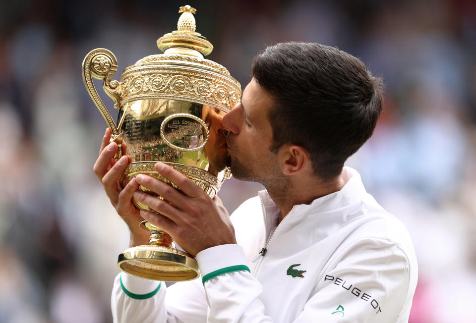 LONDON, ENGLAND - JULY 11:  Novak Djokovic of Serbia celebrates with the trophy after winning his men's Singles Final match against Matteo Berrettini of Italy on Day Thirteen of The Championships - Wimbledon 2021 at All England Lawn Tennis and Croquet Club on July 11, 2021 in London, England. (Photo by Julian Finney/Getty Images)