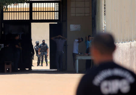 Riot police officers check inmates after clashing between rival criminal factions at a prison in Boa Vista, Brazil, October 17, 2016. REUTERS/JPavani