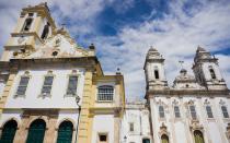 <p>Tucked into Brazil’s Northwest coast, Bahia was once the country’s capital—UNESCO protects its historic center <a rel="nofollow noopener" href="http://whc.unesco.org/en/list/309" target="_blank" data-ylk="slk:as a World Heritage site;elm:context_link;itc:0;sec:content-canvas" class="link ">as a World Heritage site</a>— but it is now known more for its <a rel="nofollow noopener" href="http://www.travelandleisure.com/articles/rhythm-of-the-city-of-all-saints" target="_blank" data-ylk="slk:spiritual heart;elm:context_link;itc:0;sec:content-canvas" class="link ">spiritual heart</a> and its vibrant African-influenced music scene.</p> <p>Wander through the colorful streets of the Pelourinho, also called the “Pelô”, to see some of the recently restored baroque architecture, and visit the many bars, shops, and restaurants that line the blocks. Pay homage to modern miracles at the Sala dos Milagres (Room of Miracles) at the 18th century church, Igreja NS do Bonfim. Marvel at the Elevador Lacerda, an art deco elevator that connects Lower and Upper Salvador, stroll along the pedestrian-only promenades in Barra, and stop in one of the city’s many restaurants to get your fill of the coconut milk-based <em>moqueca</em> stews. Be sure to visit Praia Porto da Barra beach, the picturesque beach that is book-ended by two 17th-century Portuguese fortresses, and grab a picolés (fruit popsicle) from a passing vendor. (If that spot is not to your liking, the city boasts miles of other beach options.)</p> <p>While it doesn’t coincide with the Olympics, the city comes alive during Carnival when over the course of six weeks some two million visitors flock to Salvador to take part in a high-energy street party that rivals Rio's as the best in the world.</p>