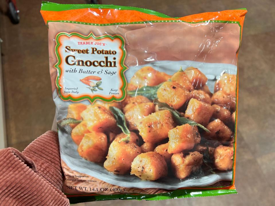 The writer holds a bag of Trader Joe's sweet-potato gnocchi