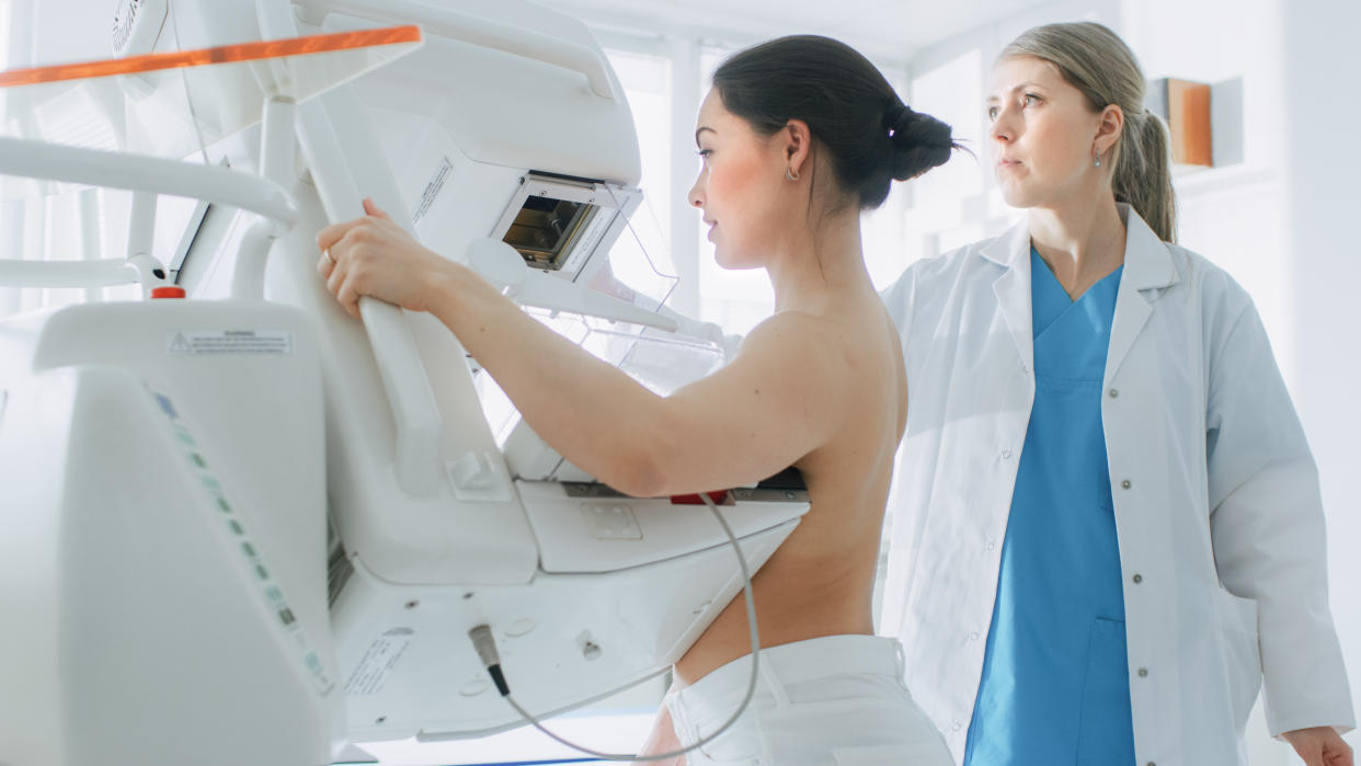 In the Hospital, Portrait Shot of Topless Female Patient Undergoing Mammogram Screening Procedure. Healthy Young Female Does Cancer Preventive Mammography Scan. Modern Hospital with High Tech Machines.