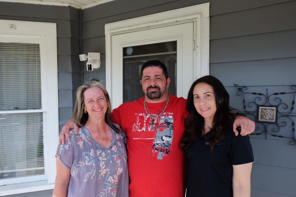 From left, Whole Living Recovery administrator and case manager Stephanie Vanbibber, Whole Living Recovery administrator Aaron Messina, and the organization's founder and director Kerry Penland on the North Lane porch.