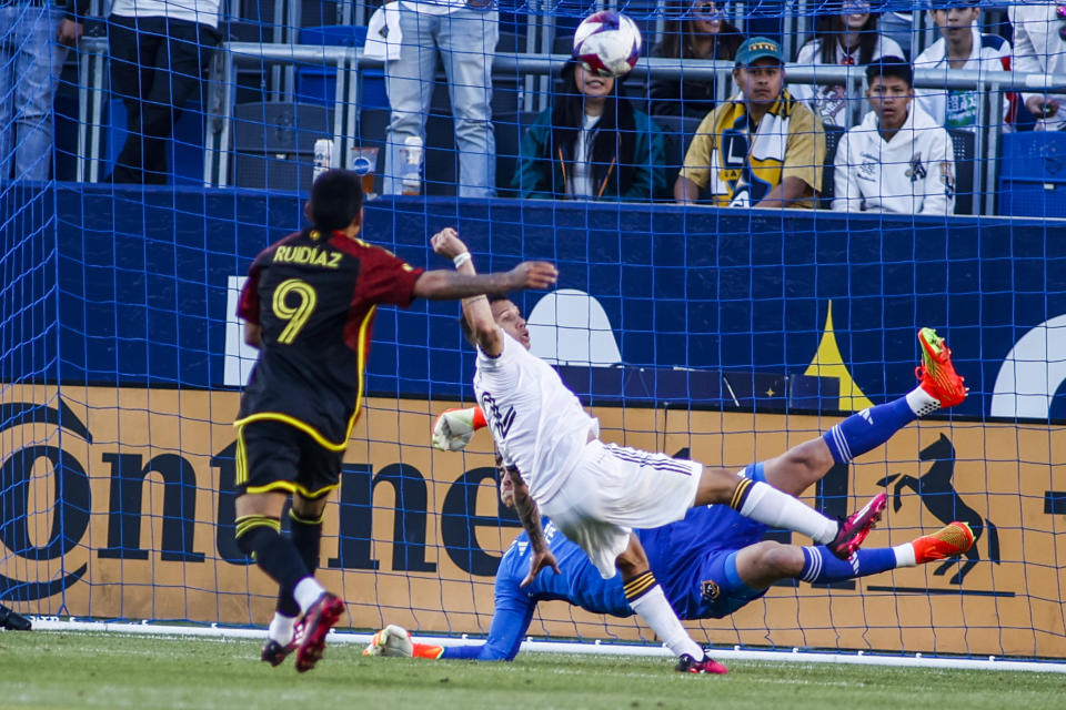 LA Galaxy goalkeeper Jonathan Klinsmann, back, makes a save in front of defender Lucas Calegari, front right, and Seattle Sounders forward Raul Ruidiaz (9) during the second half of an MLS soccer match in Carson, Calif., Saturday, April1, 2023. (AP Photo/Ringo H.W. Chiu)