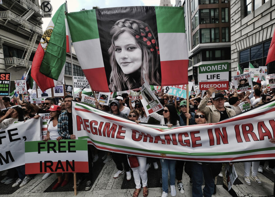 Demonstrators carry a large photo of Mahsa Amini during a protest against the Iranian regime, in Los Angeles, on Saturday, Oct. 22, 2022, following the death of Amini in the custody of the Islamic republic's notorious "morality police." Chanting crowds have rallied in Berlin, Washington DC and Los Angeles in solidarity with protesters facing a violent government crackdown in Iran. (AP Photo/Richard Vogel)