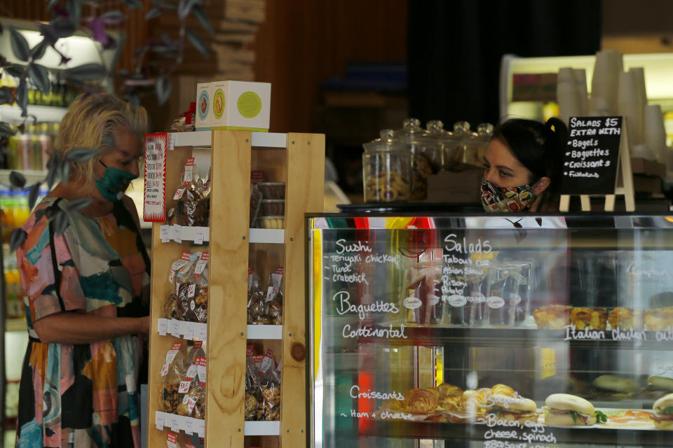 A customer and employee at a pie shop