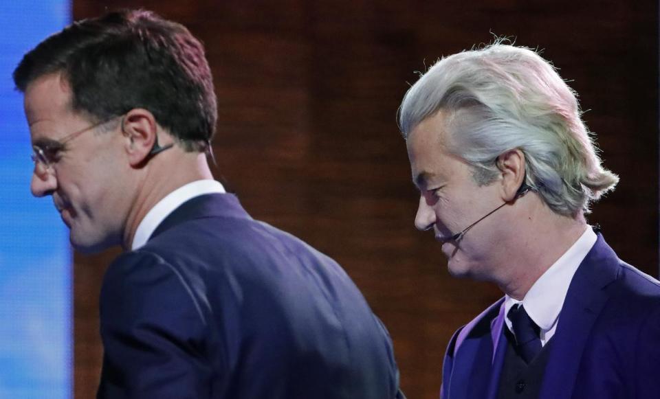 Right-wing populist leader Geert Wilders and Dutch Prime Minister Mark Rutte, left, leave the stage after a national televised debate, the first head-to-head meeting of the two political party leaders since the start of the election campaign, at Erasmus University in Rotterdam, Netherlands, Monday, March 13, 2017. (Yves Herman POOL via AP)