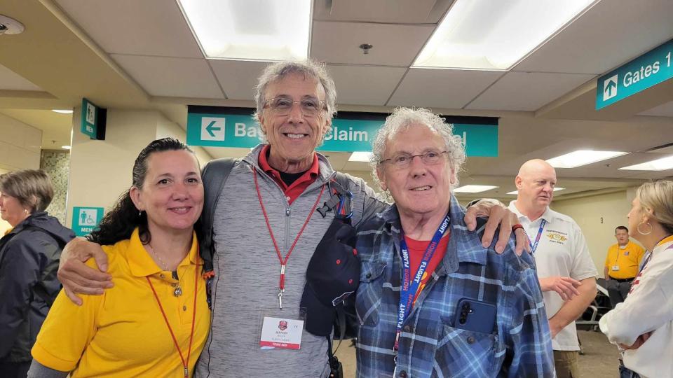 Blue Ridge Honor Flight founder Jeff Miller, center, poses with his cousin, Bob Miller, right, and his niece, Tina Dawson, on April 27 at Asheville Regional Airport.