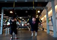 Malaysian civil engineer Kevin Lim (right) works out at a fitness centre in Kuala Lumpur, as he battles to lose weight