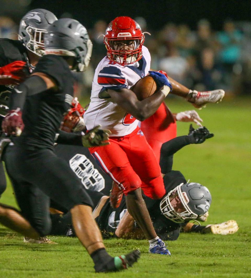 Vikings RB Eddie Love, Jr., breaks tackles as he advances the ball during the South Walton- Fort Walton Beach football game at South Walton.