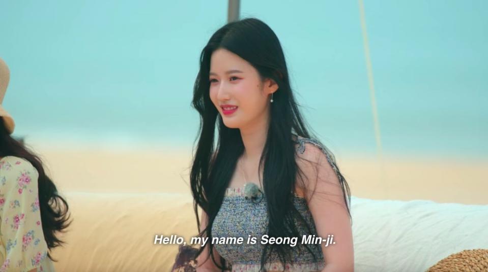 A girl smiles and introduces herself saying "Hello, my name is Seong Min-ji"