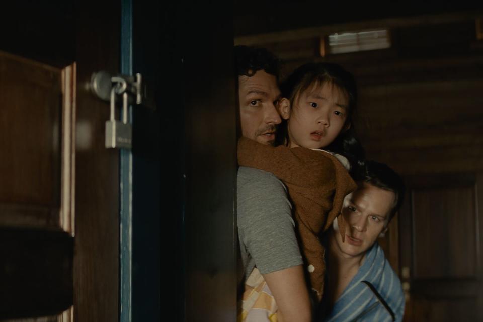 (from left) Ben Aldridge, Kristen Cui, and Jonathan Groff in KNOCK AT THE CABIN, directed and co-written by M. Night Shyamalan