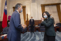 In this photo released by the Taiwan Presidential Office, U.S. Representative Mark Takano, D-Calif. left is greeted by Taiwanese President Tsai Ing-wen at the Presidential Office in Taipei, Taiwan on Friday, Nov. 26, 2021. Five U.S. lawmakers met with Taiwan President Tsai Ing-wen Friday morning in a surprise one-day visit intended to reaffirm the United States' "rock solid" support for the self-governing island. (Taiwan Presidential Office via AP)