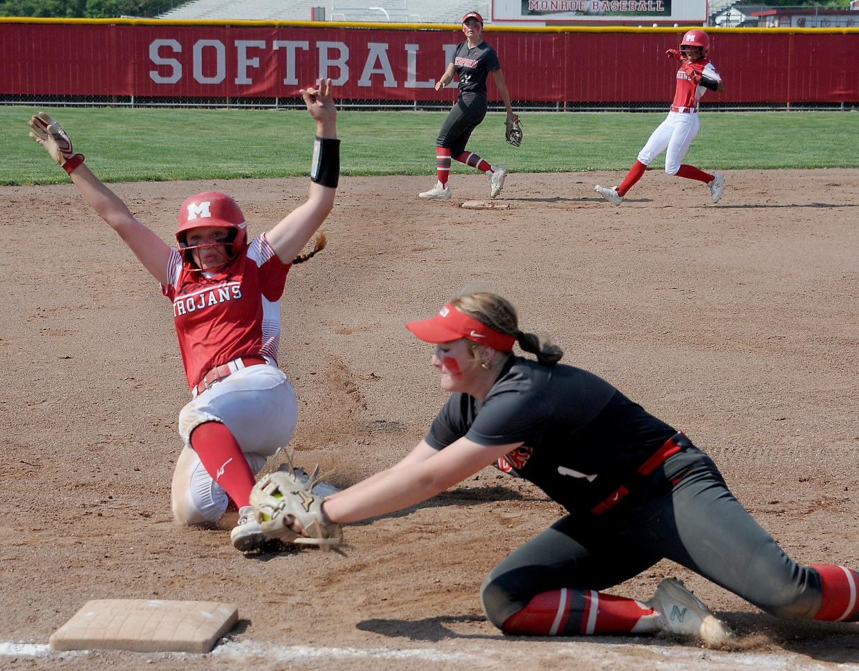 Ally Lewis of Monroe is forced out as Bedford third baseman Nyah Mullins dives to the bag in the Division 1 District semifinals at Monroe Saturday.