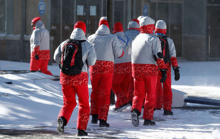 Volunteers for the upcoming 2018 Pyeongchang Winter Olympic Games walk at the Alpensia resort in Pyeongchang, South Korea, January 23, 2018. REUTERS/Fabrizio Bensch