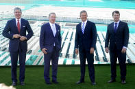 Tennessee Economic and Community Development Commissioner Bob Rolfe, left; Ford Executive Chairman Bill Ford, second from left; Tennessee Gov. Bill Lee, second from right; and Jim Farley, Ford president and CEO, right; pose together for pictures after a presentation on the planned factory to build electric F-Series trucks and the batteries to power future electric Ford and Lincoln vehicles Tuesday, Sept. 28, 2021, in Memphis, Tenn. The plant in Tennessee is to be built near Stanton, Tenn. (AP Photo/Mark Humphrey)