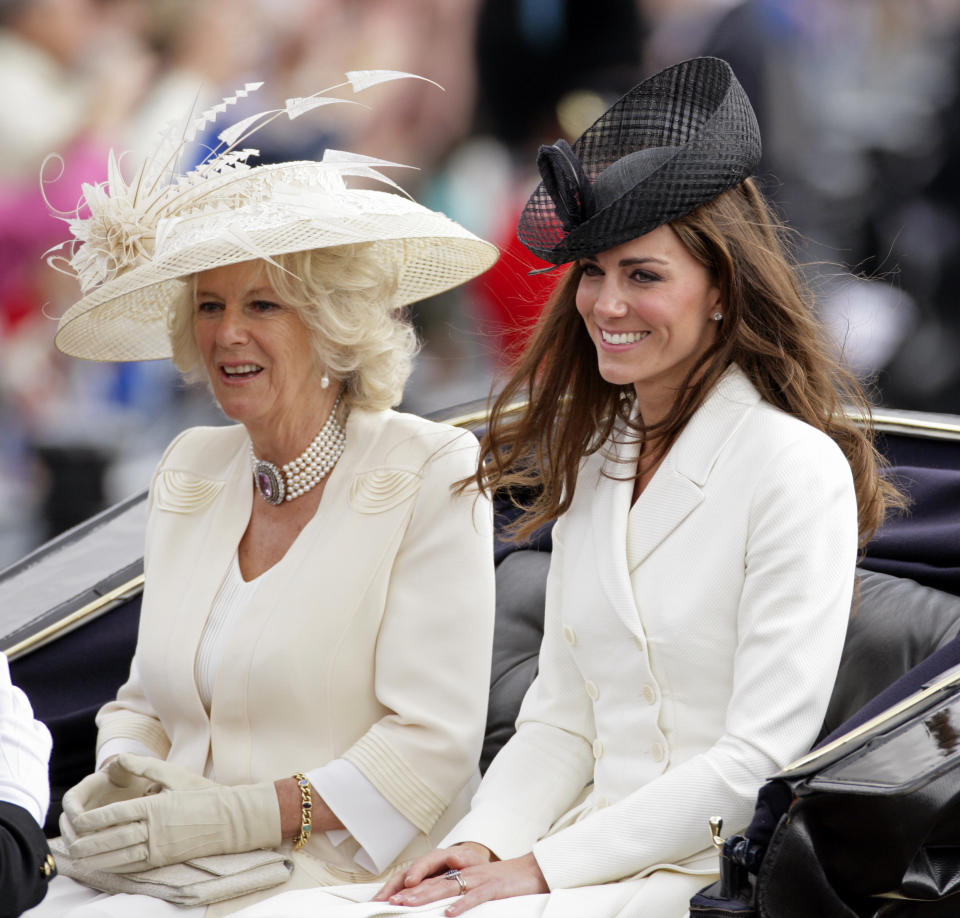 Camilla, Duchess of Cornwall, and Catherine, Duchess of Cambridge, travel down The Mall in a horse-drawn carriage as they attend the Trooping the Color parade on June 11, 2011, in London.