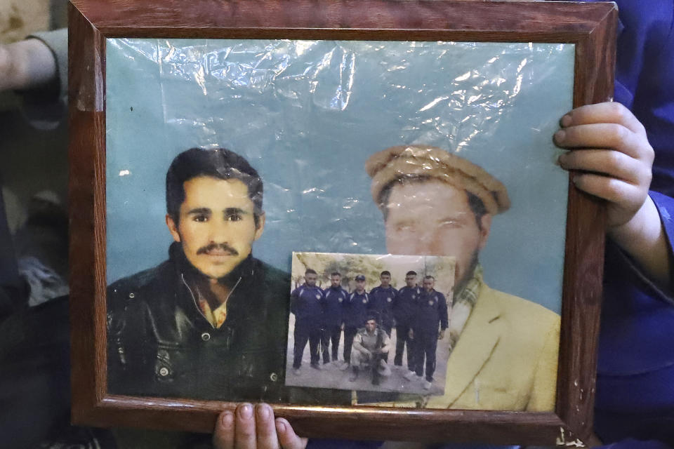A son of Mohammed Hassan, a Pakistani porter who died on July 27 during a summit of K2, holds a portrait of his father and grandfather at his home in Tasar, a village in the Shigar district in the Gilgit-Baltistan region of northern Pakistan, Saturday, Aug. 12, 2023. An investigation has been launched into the death of a Hassan near the peak of the world's most treacherous mountain, a Pakistani mountaineer said Saturday, following allegations that dozens of climbers eager to reach the summit had walked past the man after he was gravely injured in a fall. (AP Photo/M.H. Balti)