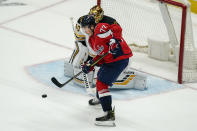 Washington Capitals right wing T.J. Oshie (77) watches a shot as Boston Bruins goaltender Tuukka Rask (40) makes a save during the second period of Game 2 of an NHL hockey Stanley Cup first-round playoff series Monday, May 17, 2021, in Washington. (AP Photo/Alex Brandon)