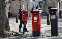 A knitted top cover for a post box depicting Britain's Queen Elizabeth II and her husband Prince Philip is exposed in Windsor, England, Friday, April 16, 2021. Prince Philip husband of Britain's Queen Elizabeth II died April 9, aged 99, his funeral will take place Saturday at Windsor Castle in St George's Chapel. The knitted top show some of Prince Philips favourite things, the Royal Yacht Britannia, right, the Duke of Edinburgh award scheme for young people and his hobby of carriage driving . (AP Photo/Alastair Grant)