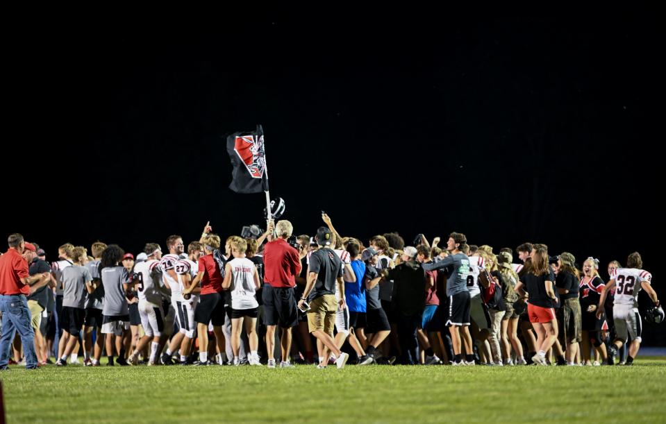 Williamsburg celebrates with their fans after beating Van Meter on Friday