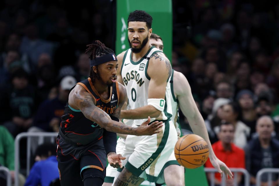 Washington Wizards' Delon Wright (55) pass the ball past Boston Celtics' Jayson Tatum (0) during the first half of an NBA basketball game, Friday, Feb. 9, 2024, in Boston. (AP Photo/Michael Dwyer)