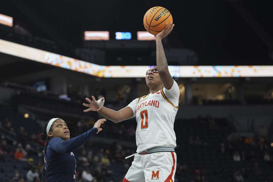 Maryland guard Shyanne Sellers (0) shoots over Illinois guard Makira Cook during the second half of an NCAA college basketball game at the Big Ten women's tournament Thursday, March 7, 2024, in Minneapolis. (AP Photo/Abbie Parr)