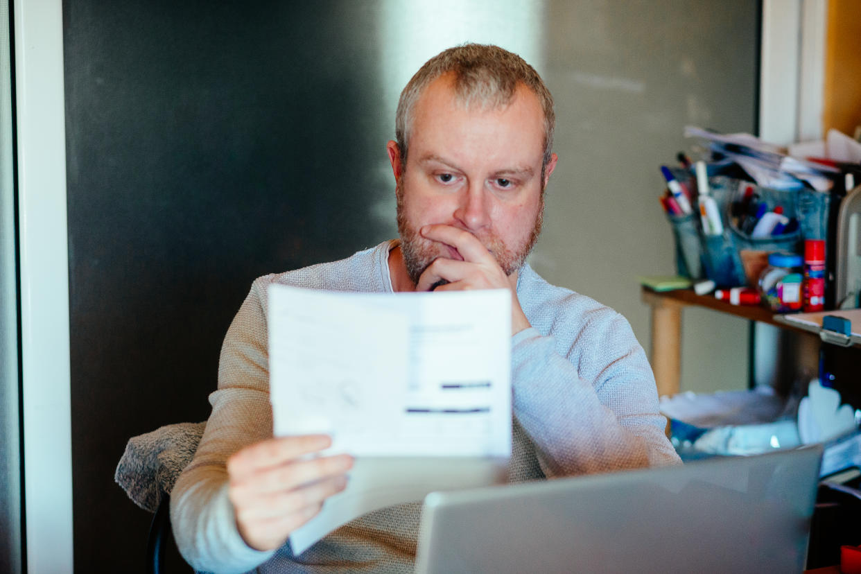 File images of man working from home, reading a document. (Getty Images)
