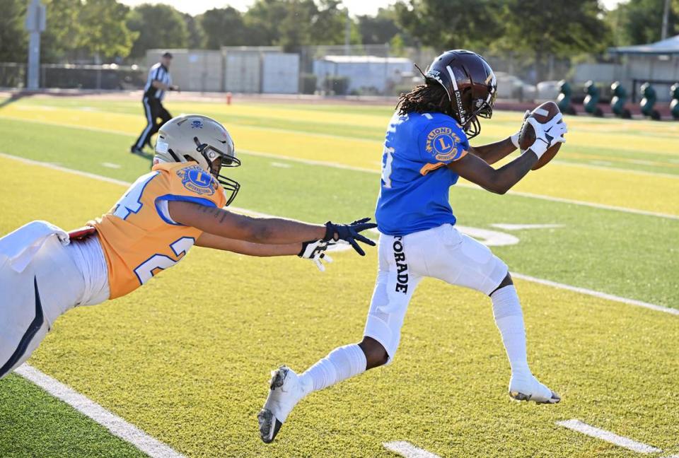 North receiver Tyree Owens (Edison) skips away from South defender Roland Brown (Central Catholic) on a catch and run for a touchdown during the Central California Lions All-Star Football Game returns at Tracy High School in Tracy, Calif., Saturday, June 24, 2023. Andy Alfaro/aalfaro@modbee.com