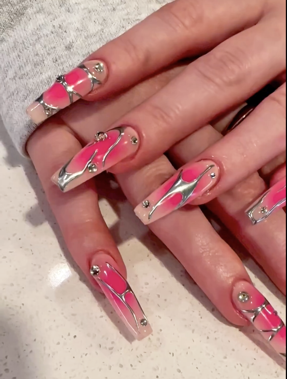 <h1 class="title">molten-chrome-nails-2024-nail-art-trends.png</h1><cite class="credit">Instagram / @nails\_of\_la</cite>