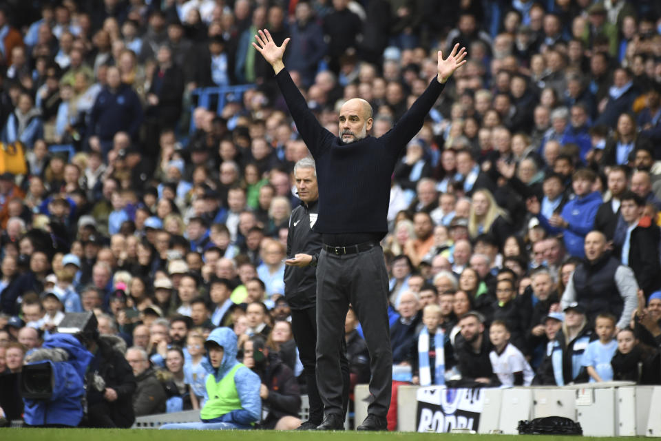 Manchester City's head coach Pep Guardiola reacts during the English Premier League soccer match between Manchester City and Luton Town at Etihad stadium in Manchester, England, Saturday, April 13, 2024. (AP Photo/Rui Vieira)