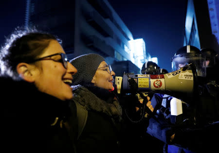 FILE PHOTO: Demonstrators shout slogans during a protest against a proposed new labor law, billed as the "slave law", outside the headquarters of the Hungarian state television in Budapest, Hungary, December 17, 2018. REUTERS/Bernadett Szabo/File Photo