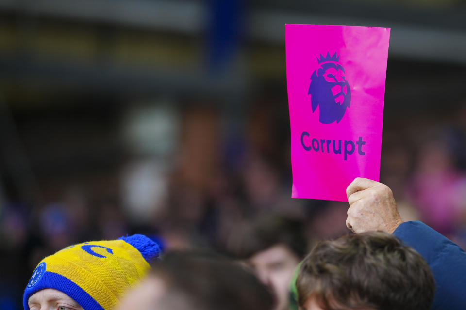 Everton supporters show cards reading "Corrupt" during the English Premier League soccer match between Everton and Aston Villa, at Goodison Park stadium in Liverpool, England, Sunday, Jan. 14, 2024. (AP Photo/Jon Super)