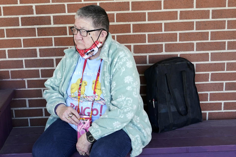 Pat Brown waits outside the Don Bosco Senior Center in Kansas City, Mo., Wednesday, March 3, 2021. Brown knows she needs the vaccine because her asthma and diabetes put her at higher risk of serious COVID-19 complications. But Wall hasn’t attempted to schedule an appointment and didn’t even know if they were being offered in her area yet; she says she is too overwhelmed. (AP Photo/Orlin Wagner)