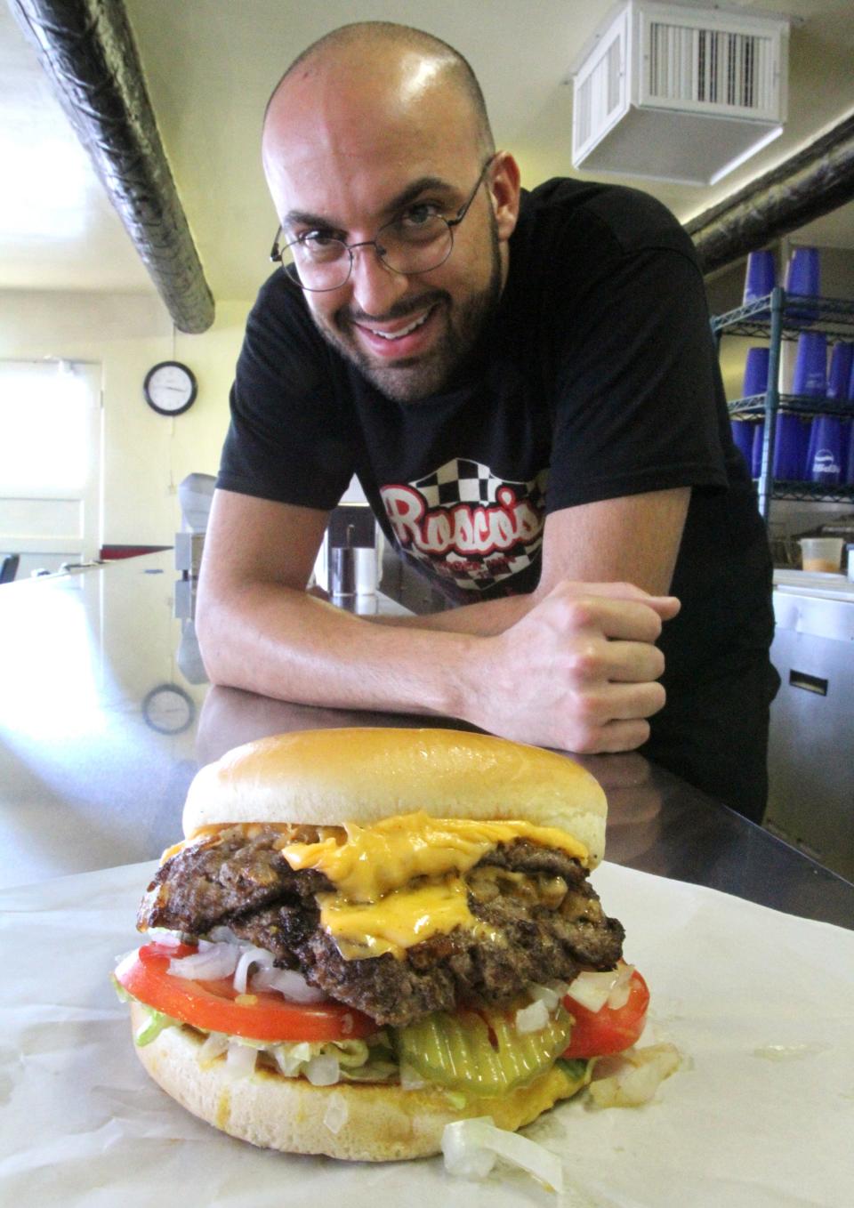 Aug. 21, 2012: Jacob Carrasco, general manager of Rosco's at 3829 Tompkins Road, shows the perennial eatery's double double burger. It features double meat and double cheese. The burger joint was founded by his grandfather, Rojelio Carrasco, in 1955.