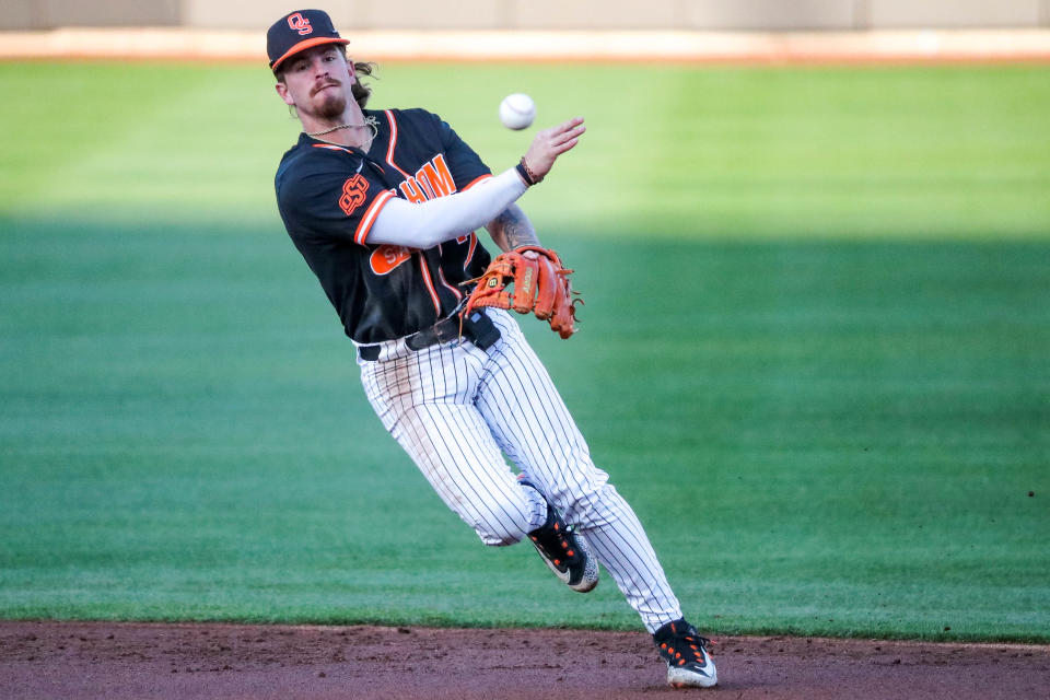 OSU's Roc Riggio throws to first base for an out Saturday against Baylor at O’Brate Stadium in Stillwater.