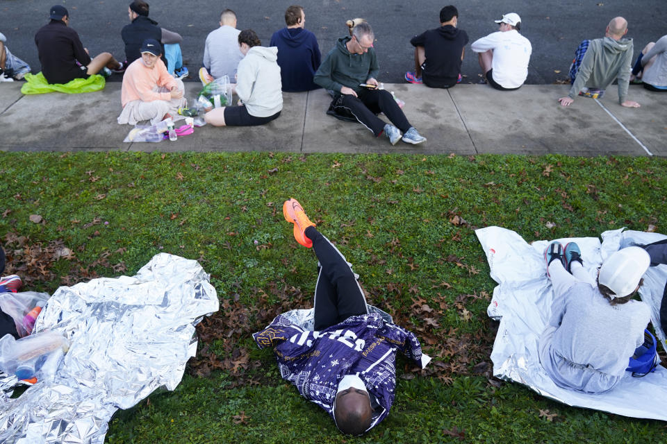 Runners rest before the start of the New York City Marathon in New York, Sunday, Nov. 6, 2022. (AP Photo/Seth Wenig)